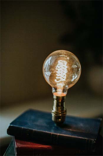 An old fashioned light bulb is glowing